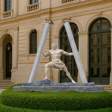 Grand outdoor sculpture depicting a muscular classical warrior in a powerful stance, holding two broken pillars apart, symbolizing strength and resilience, displayed in front of a neoclassical building façade.