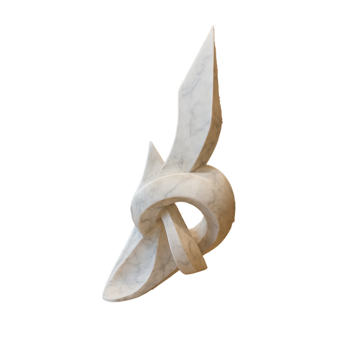 Grand abstract knot-inspired sculpture in a white marble finish with natural veining, displayed in a luxurious hotel lobby with elegant columns and warm ambient lighting.