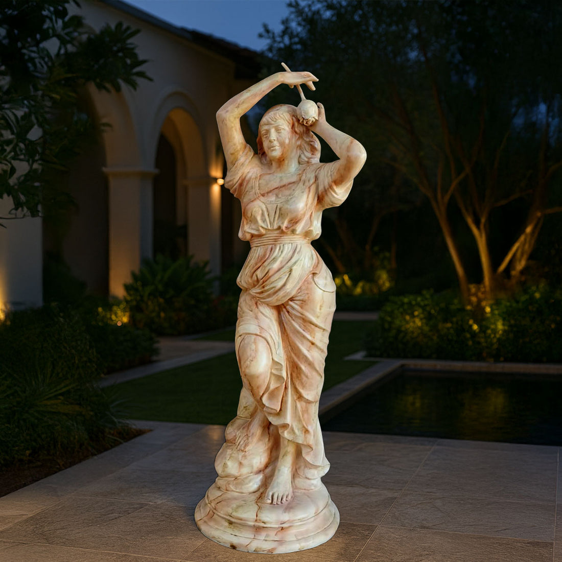 Graceful marble-finish sculpture of a dancing lady with flowing drapery, displayed in a luxurious outdoor villa setting near a pool and garden.