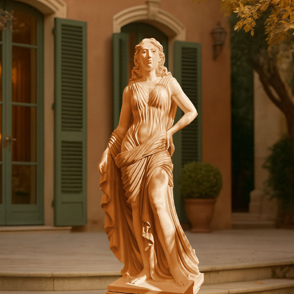 Elegant terracotta beige finish sculpture of a classical lady in flowing drapery, displayed in a Mediterranean-style courtyard with green shutters and potted plants.