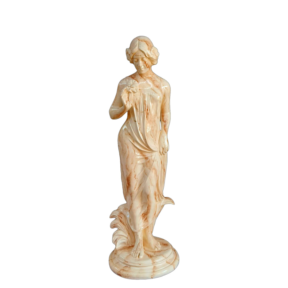 Graceful lady sculpture in a soft marble finish, holding a flower and draped in flowing attire, displayed outdoors against a vine-covered wall and greenery.