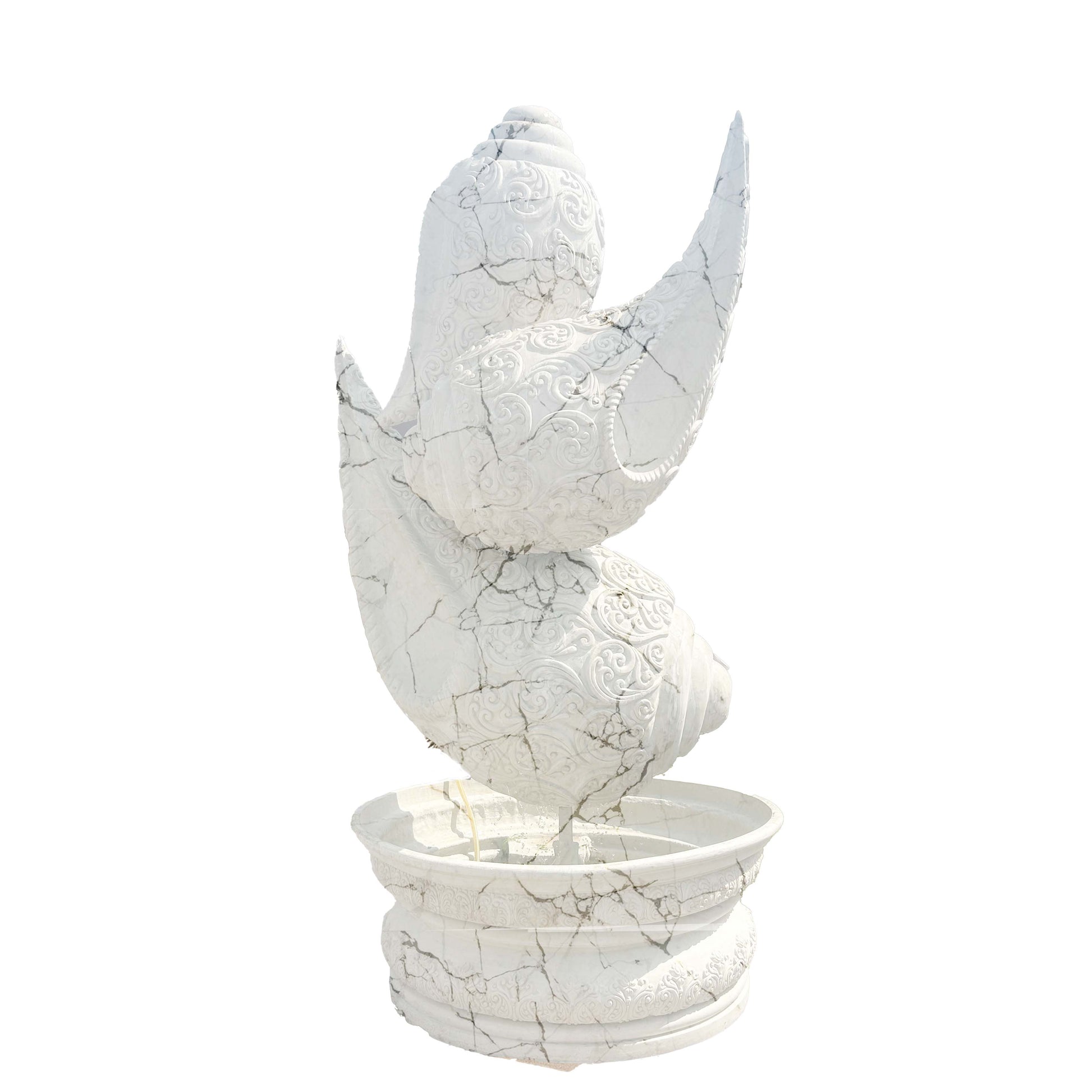 Intricately carved white marble-finish shankh (conch shell) fountain sculpture with detailed textures, placed on a pedestal basin in a luxury garden entrance setting.