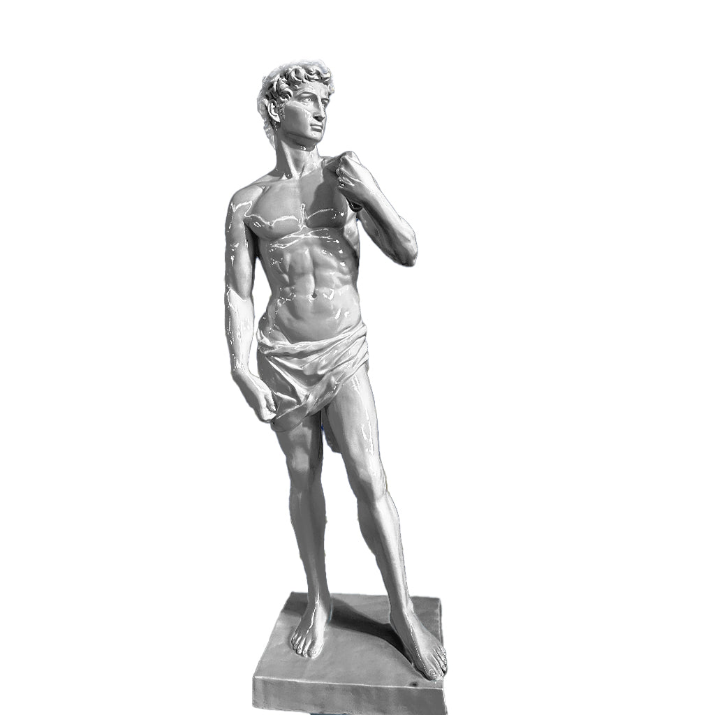Striking silver-toned sculpture inspired by Michelangelo’s David, displayed in a sophisticated interior with deep blue walls and golden detailing.