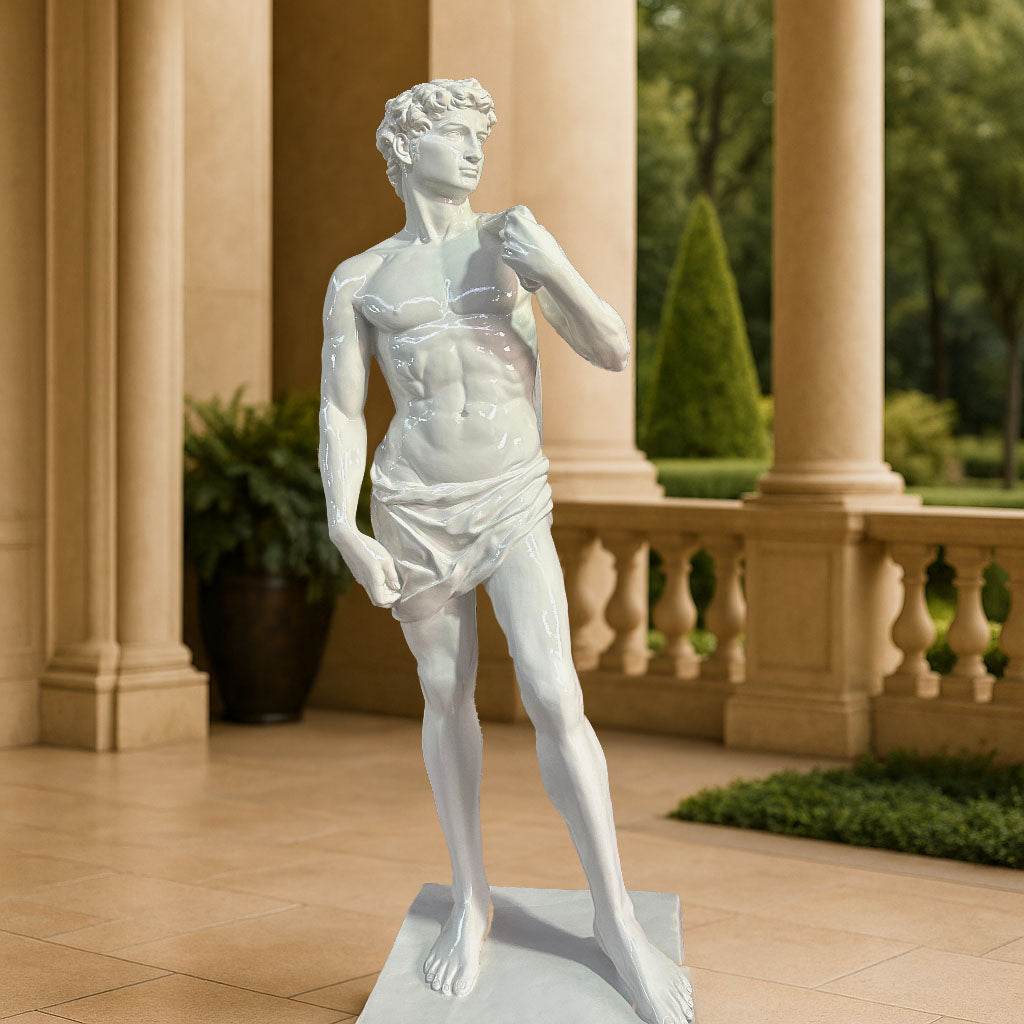 Elegant white glossy finish sculpture inspired by Michelangelo’s David, displayed in a luxurious outdoor courtyard with grand pillars and landscaped greenery.