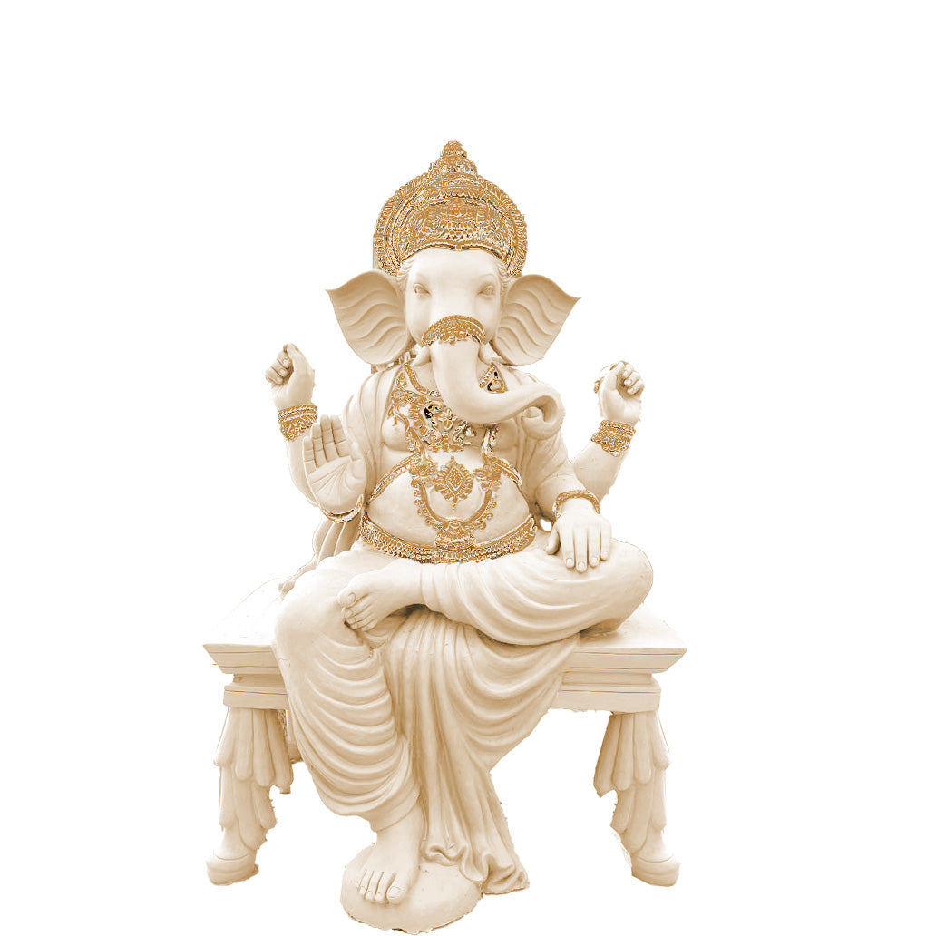 Intricately crafted Lord Ganesha sculpture in white finish with golden detailing, seated on a decorative pedestal inside a traditional Indian temple-style interior.